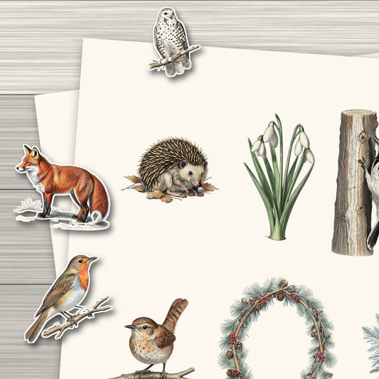 Close-up of a printed Winter Woodland ephemera sheet with cut-out fox, robin and owl pieces