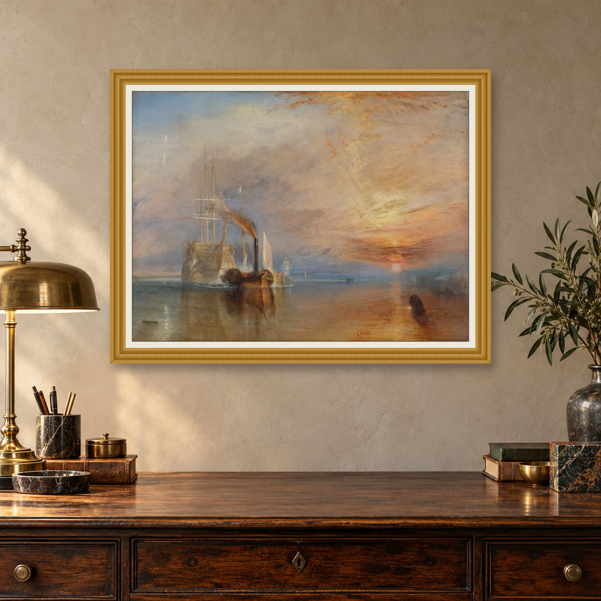 The Fighting Temeraire by J. M. W. Turner — ornate gold frame, antique writing desk mockup
