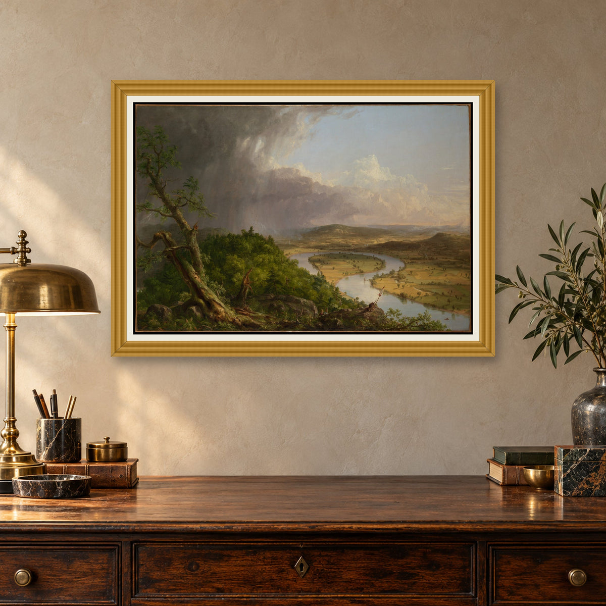 The Oxbow by Thomas Cole — ornate gold frame, antique writing desk mockup